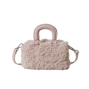 Soft pink faux fur square handbag featuring a smooth top handle and shoulder strap