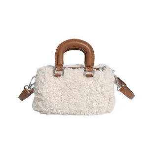 Detail shot of white faux fur handbag featuring elegant brown leather-style handles.