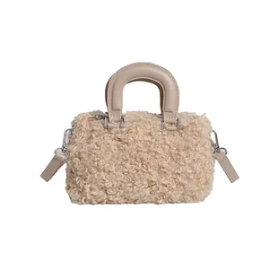 Detailed front view of beige fuzzy sherpa square handbag with a smooth top handle