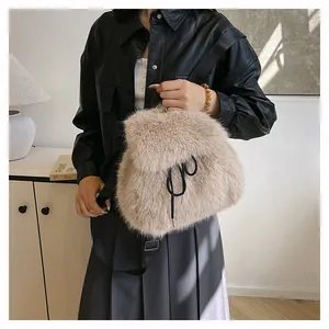 Chic beige faux fur bucket bag shown in a stylish lifestyle indoor setting