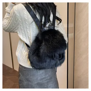 Rear view of a soft black faux fur backpack with drawstring closure and webbed straps