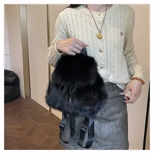 Fluffy black faux fur backpack bucket bag shown on model for a cozy winter style