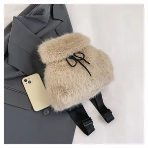 Detailed view of a soft beige faux fur drawstring backpack with adjustable black straps