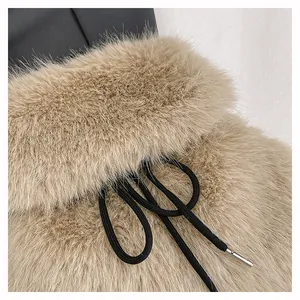 Close-up of soft faux fur texture and black drawstring on a stylish beige bucket bag.