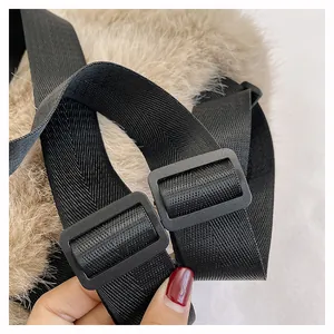 Detailed view of the adjustable black shoulder strap buckle on a soft plush backpack