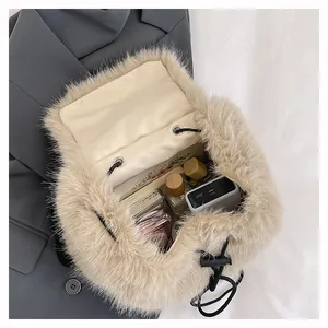 Interior view of soft beige plush drawstring bucket bag showing storage capacity