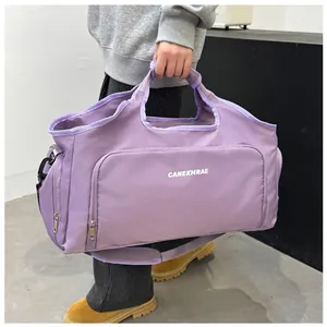 Large capacity purple travel duffle bag held by hand for gym or short weekend trips