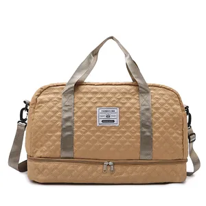 Detailed view of khaki quilted travel bag with double handles and shoulder strap