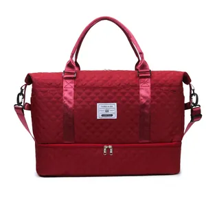 Red quilted sports travel bag with a separate shoe compartment at the bottom