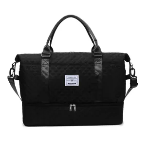Front view of black quilted travel duffel bag featuring a separate shoe compartment.