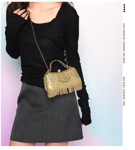 Detailed view of luxury gold fringe evening clutch bag with chain strap on model