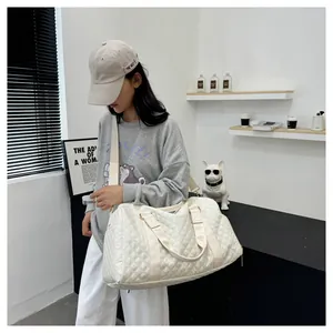 Casual white quilted duffel bag on model, perfect for travel, fitness and gym use