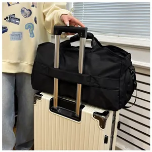 Close-up detail showing the black travel duffel bag securely attached to a suitcase handle