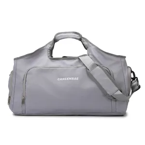 Front view of a large gray travel duffel bag with sturdy handles and shoulder strap