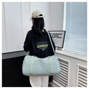 Mint green quilted sports travel bag for fitness and short trips shown on a person