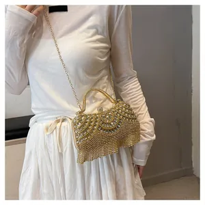 Detail view of the sparkling gold rhinestone fringe evening clutch with chain strap.