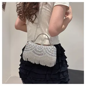 Rear view of a sparkling silver rhinestone evening clutch bag with fringe detail