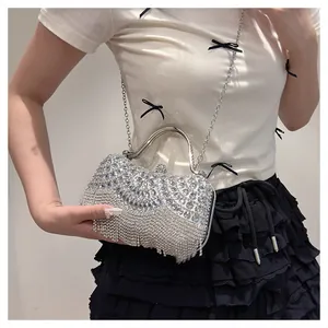 Detail shot of elegant silver rhinestone evening clutch bag with fringe tassels
