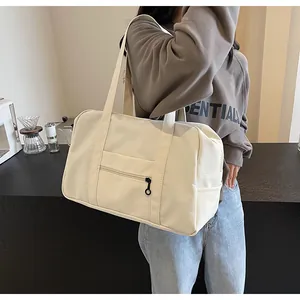 Cream large capacity nylon tote bag for travel and fitness, lifestyle model shot details.