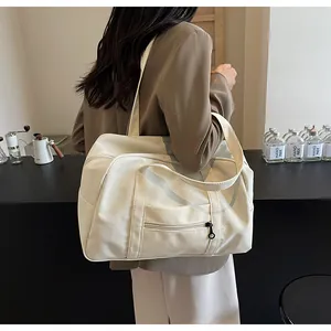 Large capacity white nylon tote bag shown from a side view being carried by a model.