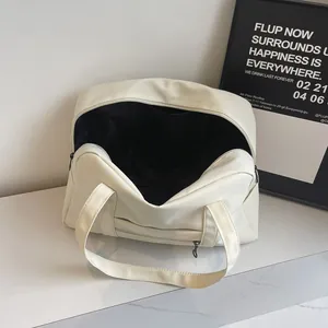 Detail view of large capacity nylon travel tote bag showing black interior lining