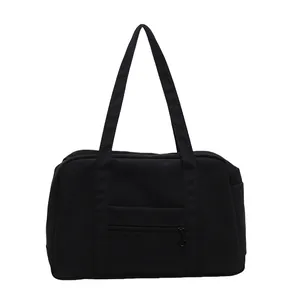 High-quality minimalist black nylon sports tote bag featuring a front zipper pocket detail