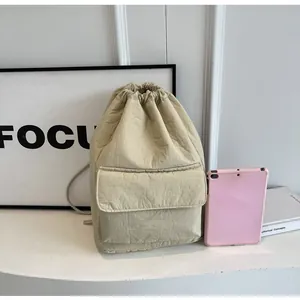 Lightweight nylon drawstring bucket backpack in beige with functional front pocket