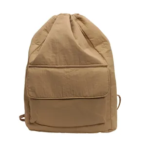 High-quality detail view of a khaki drawstring nylon backpack featuring front flap pocket