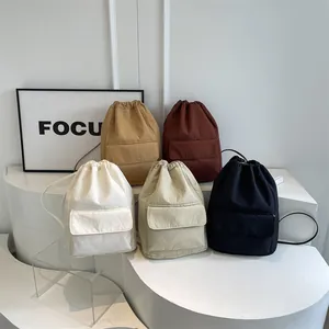 Multi-color nylon drawstring bucket backpacks with large capacity and minimalist design.
