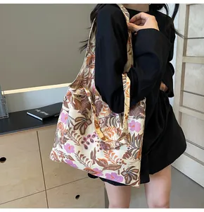 Lifestyle view of a vintage floral print canvas tote bag with large capacity for women