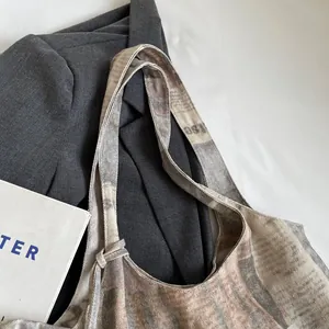 Detail showing the durable canvas shoulder strap and top edge of a printed tote bag