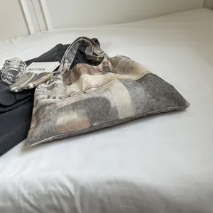 Stylish vintage newspaper print canvas tote bag shown with a matching small pouch