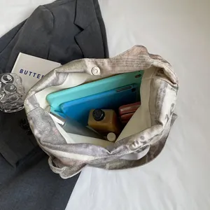 Detailed interior view of a large capacity printed canvas tote bag for daily commuting