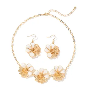 Elegant gold-tone flower necklace and earrings set with white enamel petals