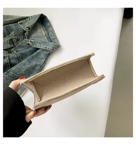 Detailed view showing the spacious interior of a solid color felt handbag for daily use