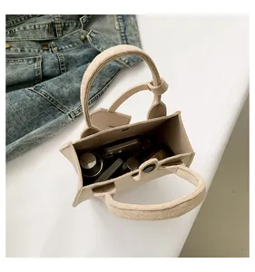 Top view of beige minimalist tote bag showing spacious interior and magnetic snap closure