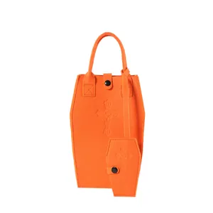 Vibrant orange coffin-shaped felt tote bag set with an embossed gothic cross detail