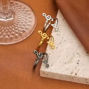 Detailed macro shot of three musical note rings in gold, silver and black finishes