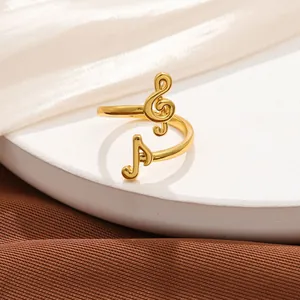 Detail of gold-plated adjustable music note ring with G-clef and musical motif for lovers.