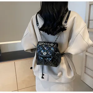 Vue de dos d'une femme portant un sac à dos seau matelassé noir avec cordon de serrage