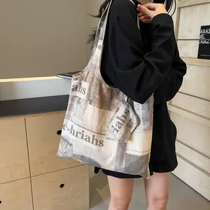 Stylish large capacity canvas tote bag with newspaper print and matching small pouch