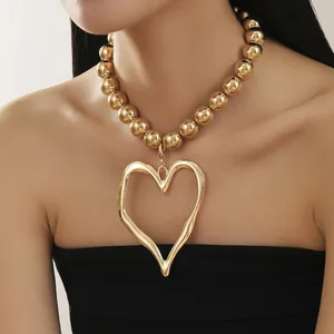 Exaggerated gold bead necklace with large irregular hollow heart pendant for women