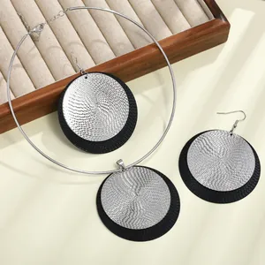 Detalle de cerca del elegante conjunto de joyas con colgante y pendientes circulares