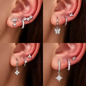 Set of four styles of silver-tone zirconia earrings showing various ear piercing combinations.