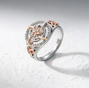 Detailed view of a two-tone Celtic knot ring set with sparkling cubic zirconia stones