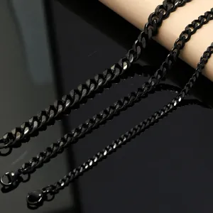 Detail shot of three different widths of black stainless steel Cuban link chains