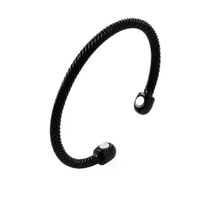 Detail of a minimalist black twisted cable cuff bracelet with circular magnetic ends