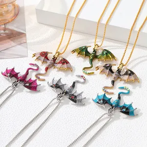 Detailed view of colorful vintage enamel flying dragon pendants with rhinestone accents