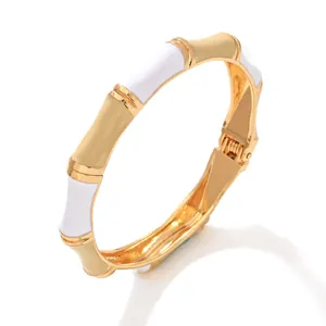 Elegant enamel bamboo bangle in malt yellow and white with gold finish.