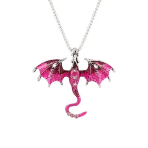Detailed view of vintage pink enamel dragon pendant with sparkling crystals.